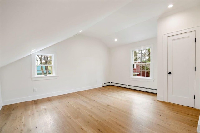 1000 Washington Dr, Centerport, NY 11721 - bonus room featuring a baseboard heating unit, lofted ceiling, light wood-type flooring, and recessed lighting