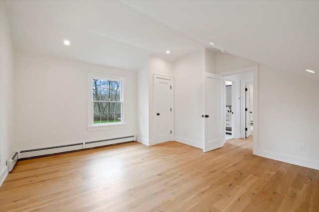 1000 Washington Dr, Centerport, NY 11721 - empty room with a baseboard heating unit, light wood-style flooring, and recessed lighting