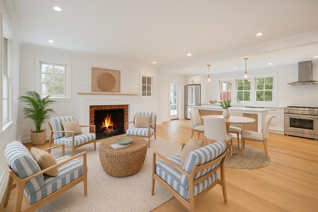 1000 Washington Dr, Centerport, NY 11721 - living room featuring a brick fireplace, light wood-style floors, recessed lighting, and crown molding