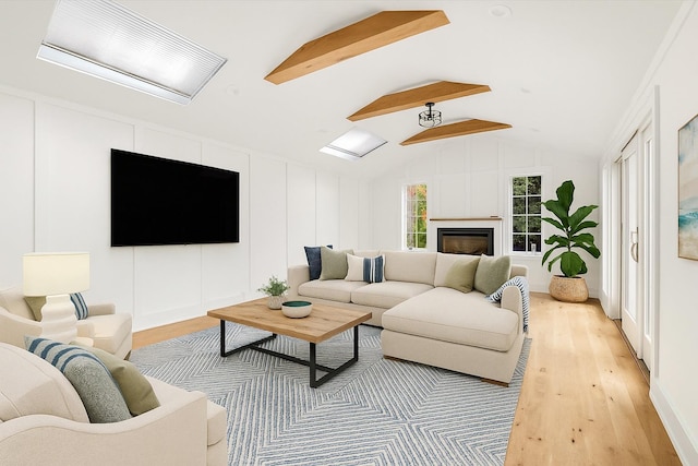1000 Washington Dr, Centerport, NY 11721 - living area featuring light wood finished floors, lofted ceiling, and a fireplace