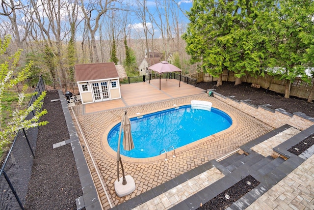 view of pool with a fenced in pool, a fenced backyard, and a deck
