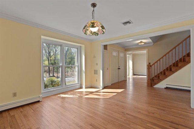 interior space with a baseboard heating unit, visible vents, baseboard heating, wood finished floors, and stairs