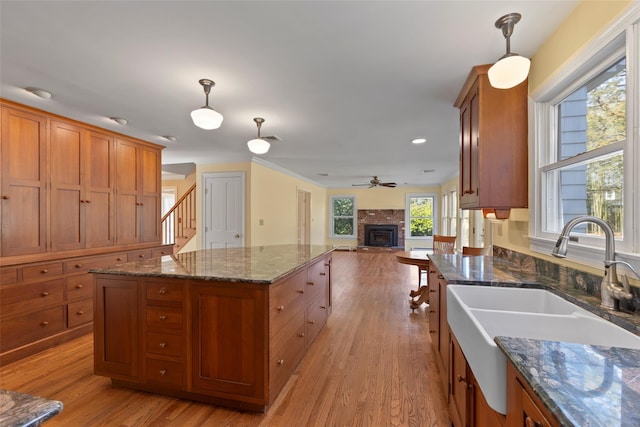 kitchen featuring light wood-style flooring, a sink, and brown cabinets