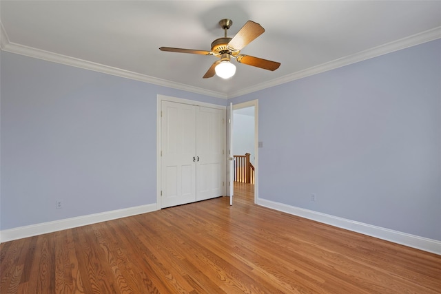 unfurnished bedroom with light wood-type flooring, baseboards, and ornamental molding