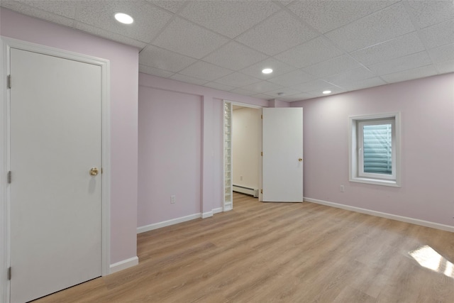 unfurnished bedroom featuring light wood-type flooring, recessed lighting, and a baseboard radiator