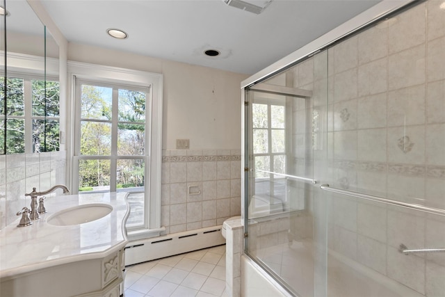 bathroom featuring a shower with shower door, tile patterned floors, baseboard heating, tile walls, and visible vents