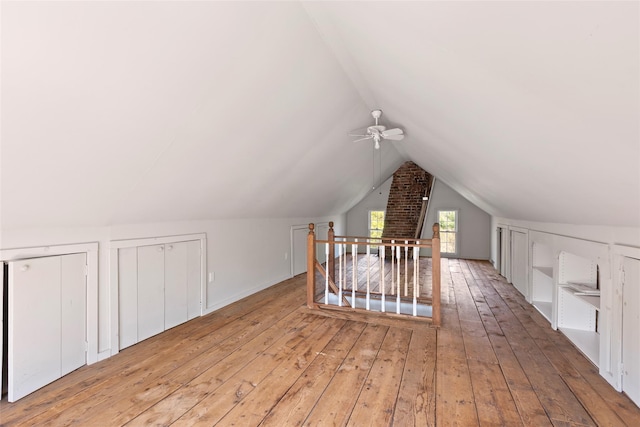 bonus room featuring wood-type flooring, ceiling fan, and vaulted ceiling