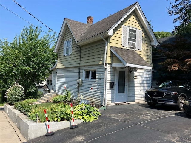 19 Tatterson St, Roslyn, NY 11576 - view of front of property with a chimney and roof with shingles