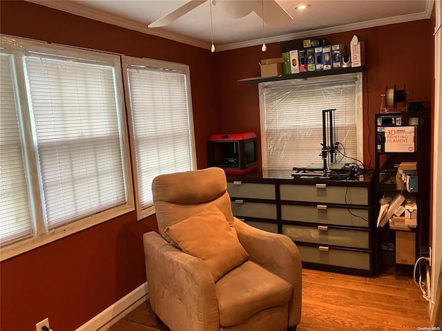 19 Tatterson St, Roslyn, NY 11576 - sitting room with wood finished floors, crown molding, and ceiling fan