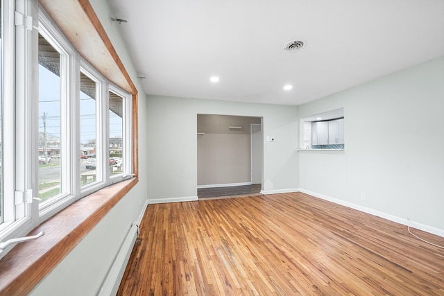 unfurnished bedroom featuring recessed lighting, visible vents, wood finished floors, and baseboards