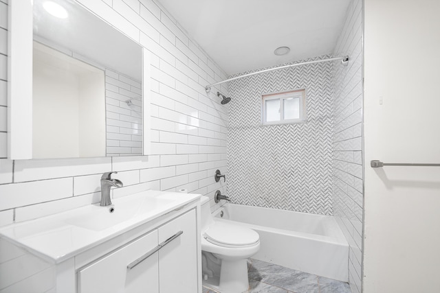 full bath featuring tile walls, vanity, decorative backsplash, toilet, and tub / shower combination