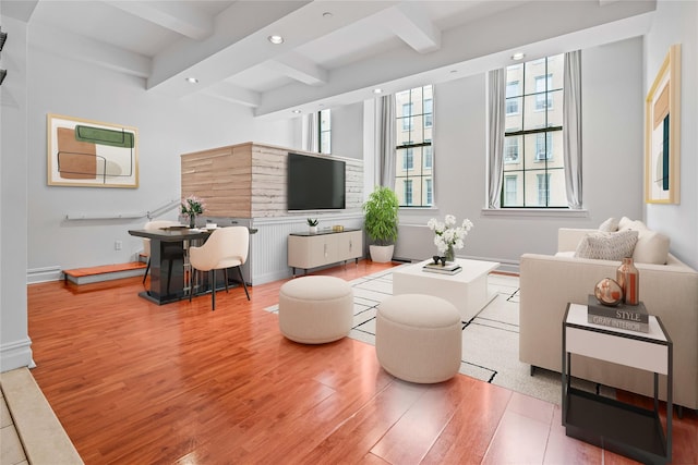 living room featuring wood finished floors, beamed ceiling, recessed lighting, and baseboards