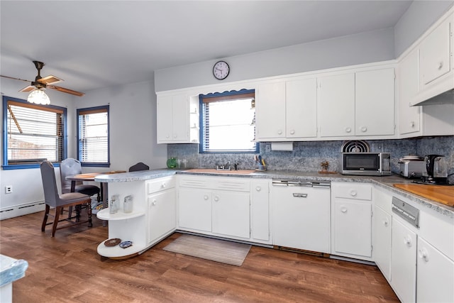 420 Old Country Rd, Melville, NY 11747 - kitchen featuring decorative backsplash, dishwasher, stainless steel microwave, and white cabinetry