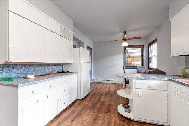 420 Old Country Rd, Melville, NY 11747 - kitchen with a ceiling fan, wood finished floors, a baseboard heating unit, white cabinetry, and freestanding refrigerator