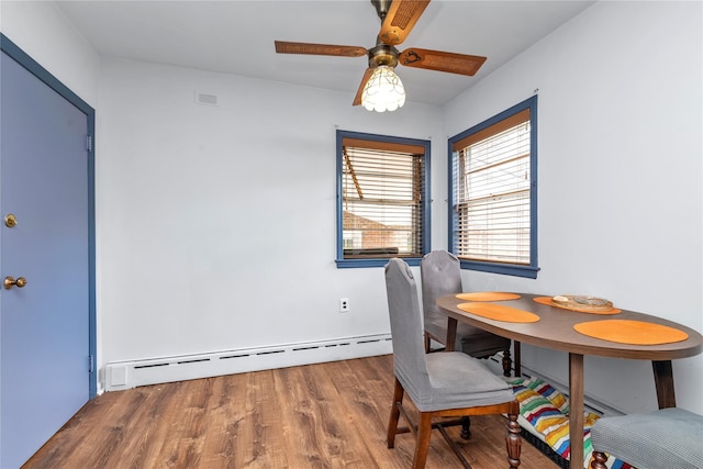 420 Old Country Rd, Melville, NY 11747 - dining area featuring a baseboard heating unit, ceiling fan, wood finished floors, and visible vents