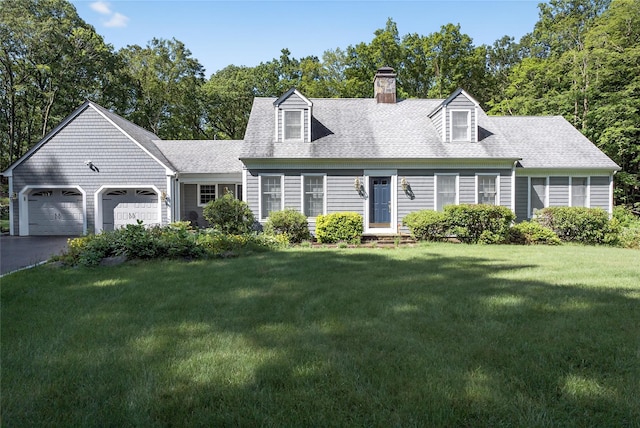 41 Lavelle Rd, Holmes, NY 12531 - cape cod-style house featuring a chimney, an attached garage, a front lawn, driveway, and a shingled roof