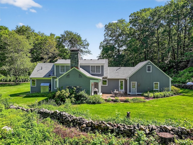 41 Lavelle Rd, Holmes, NY 12531 - back of property featuring a patio, a lawn, a chimney, and roof with shingles