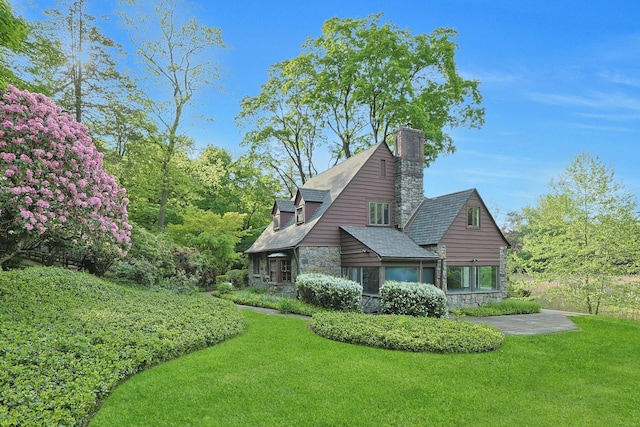 300 Sheldon Ave, Tarrytown, NY 10591 - view of side of property with stone siding, a yard, and a chimney