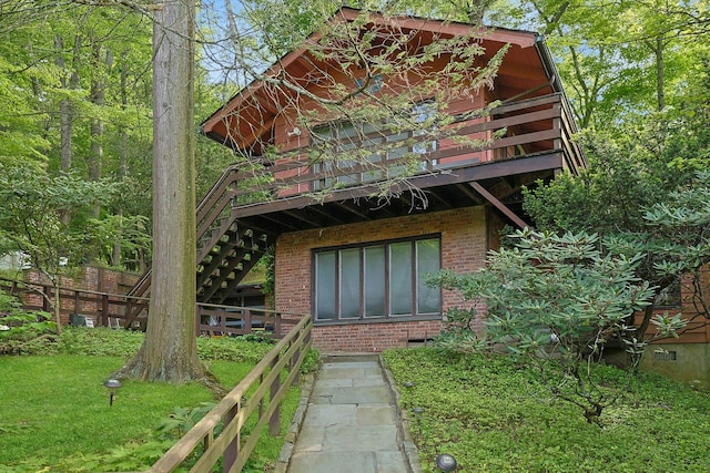 300 Sheldon Ave, Tarrytown, NY 10591 - rear view of property with brick siding, stairway, a deck, and a lawn