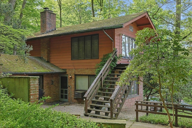 300 Sheldon Ave, Tarrytown, NY 10591 - back of property featuring a chimney, stairway, and brick siding