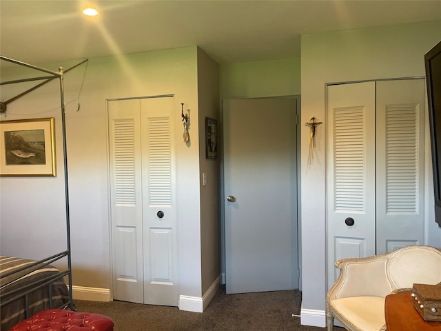 bedroom with baseboards, a closet, and dark colored carpet