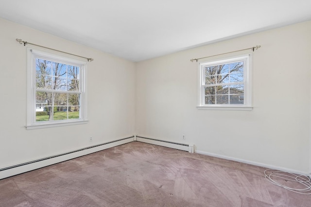empty room with carpet, a wealth of natural light, and baseboards