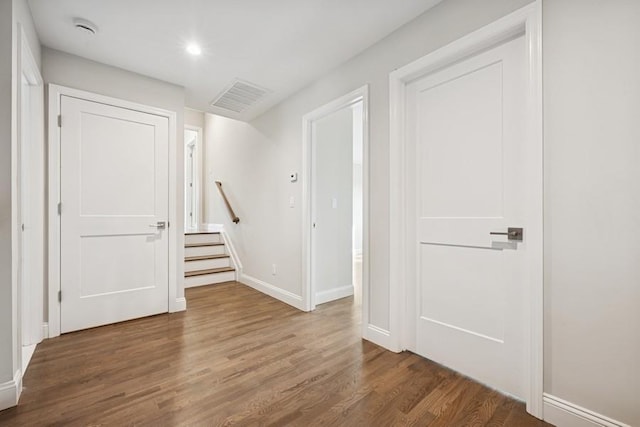 foyer entrance featuring wood finished floors, baseboards, and recessed lighting