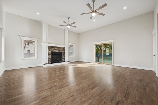 148 S 5th St, Lindenhurst, NY 11757 - unfurnished living room featuring a stone fireplace, ceiling fan, high vaulted ceiling, wood finished floors, and recessed lighting