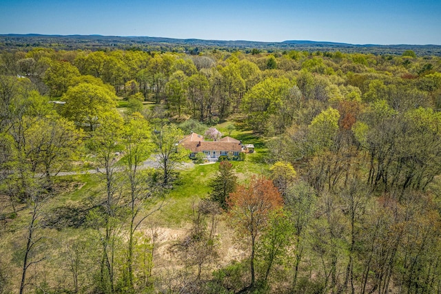 view from above of property with a heavily wooded area