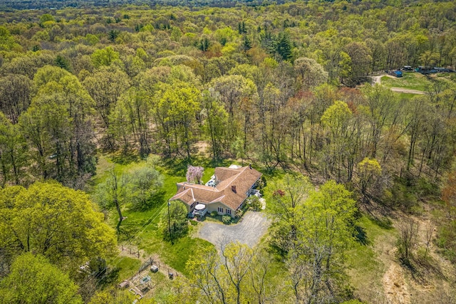 view of subject property with a heavily wooded area