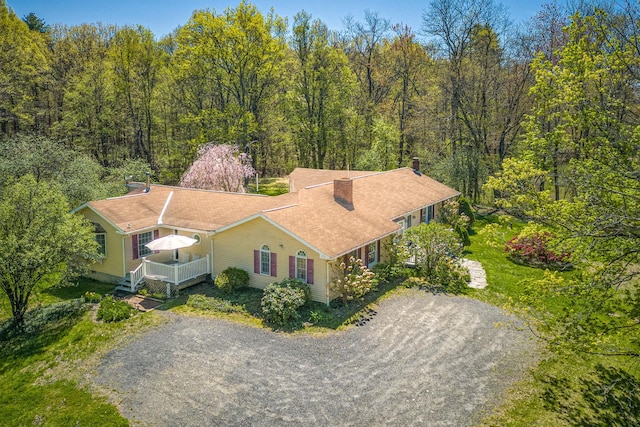 view of subject property featuring a heavily wooded area