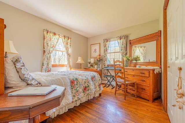bedroom featuring light wood-type flooring and a baseboard radiator