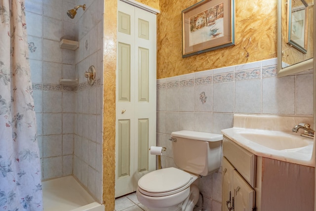 full bathroom featuring a stall shower, vanity, toilet, and tile walls