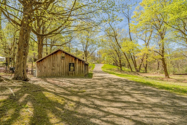 view of side of property with board and batten siding and an outbuilding