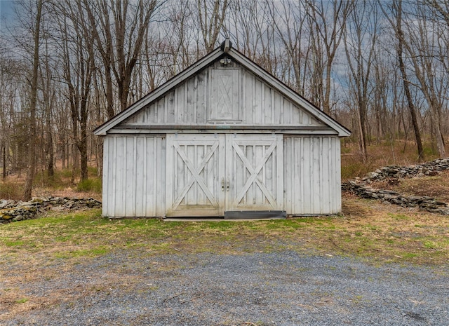 view of shed with a wooded view