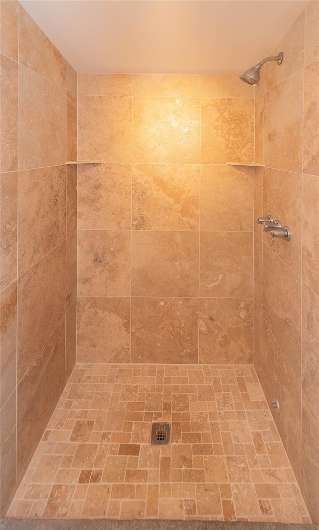 bathroom with tiled shower