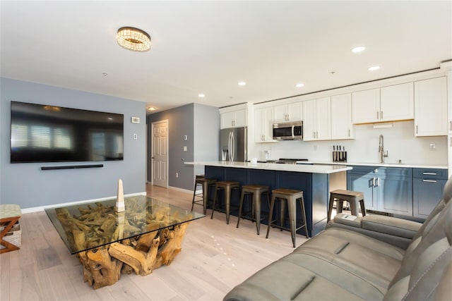 243 Sportsmans Ave, Freeport, NY 11520 - living room with recessed lighting, light wood-style floors, and baseboards