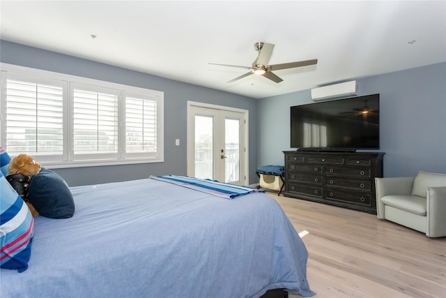 243 Sportsmans Ave, Freeport, NY 11520 - bedroom with a wall mounted air conditioner, wood finished floors, a ceiling fan, french doors, and access to outside