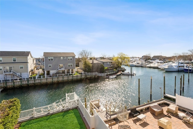 243 Sportsmans Ave, Freeport, NY 11520 - view of dock with fence, a patio area, a residential view, and a water view