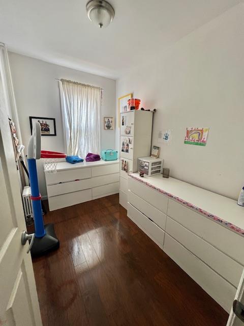 bedroom with dark wood-type flooring