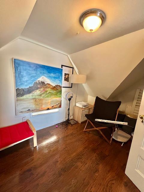 additional living space with vaulted ceiling and wood finished floors