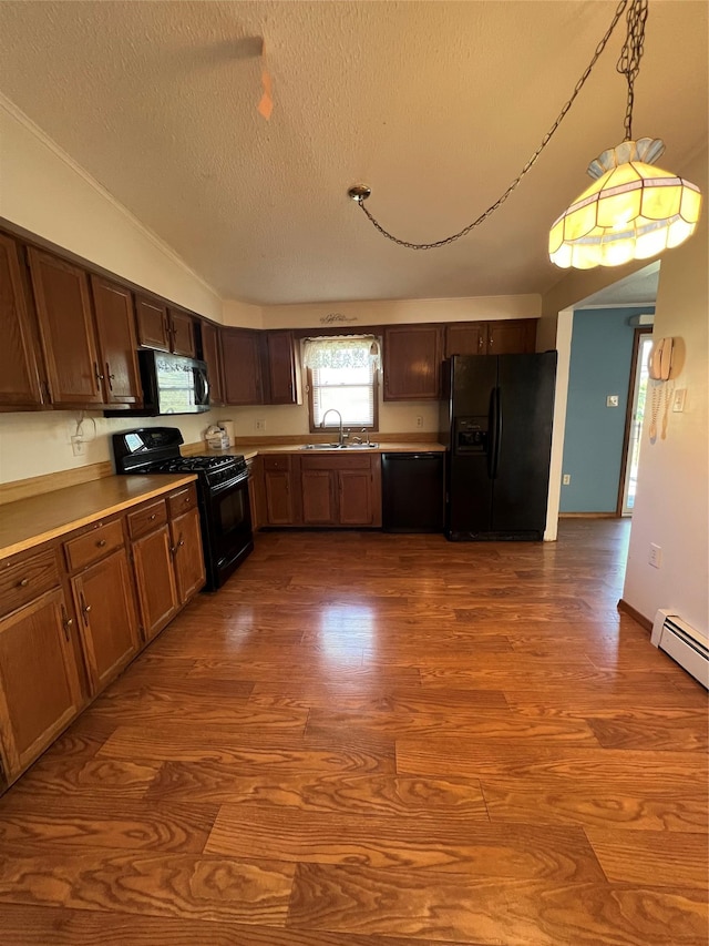 11 Keats Rd, Middletown, NY 10941 - kitchen with black appliances, dark wood finished floors, a textured ceiling, a sink, and light countertops