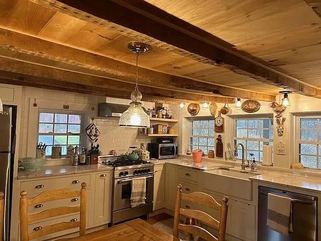 70 Mill Road Ext, Hyde Park, NY 12538 - kitchen featuring appliances with stainless steel finishes, wooden ceiling with exposed beams, a sink, wine cooler, and healthy amount of natural light
