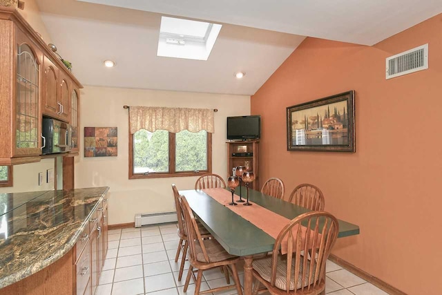 dining room featuring baseboard heating, lofted ceiling with skylight, light tile patterned floors, baseboards, and visible vents