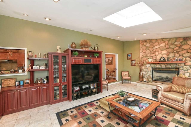 living room featuring a fireplace, recessed lighting, and a skylight