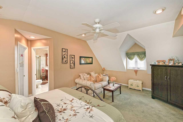 carpeted bedroom featuring vaulted ceiling, baseboards, recessed lighting, ceiling fan, and ensuite bath