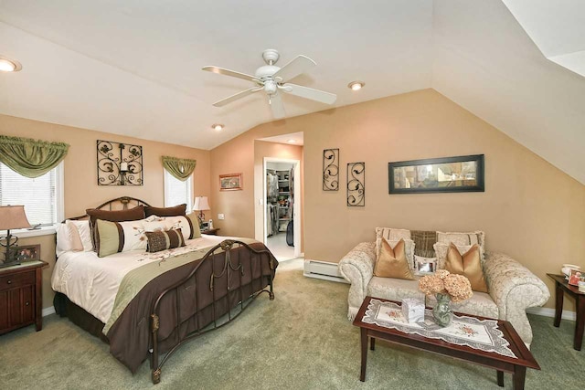 bedroom featuring multiple windows, a walk in closet, vaulted ceiling, and light carpet