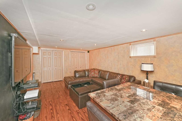 living room with recessed lighting, wood finished floors, and ornamental molding