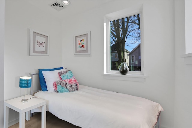 bedroom featuring wood finished floors, visible vents, and recessed lighting