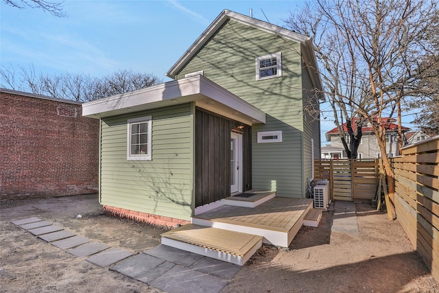 rear view of house with fence